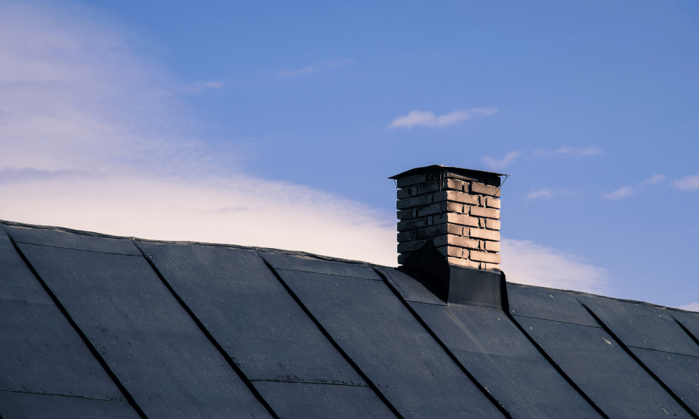Technician installing new chimney cap